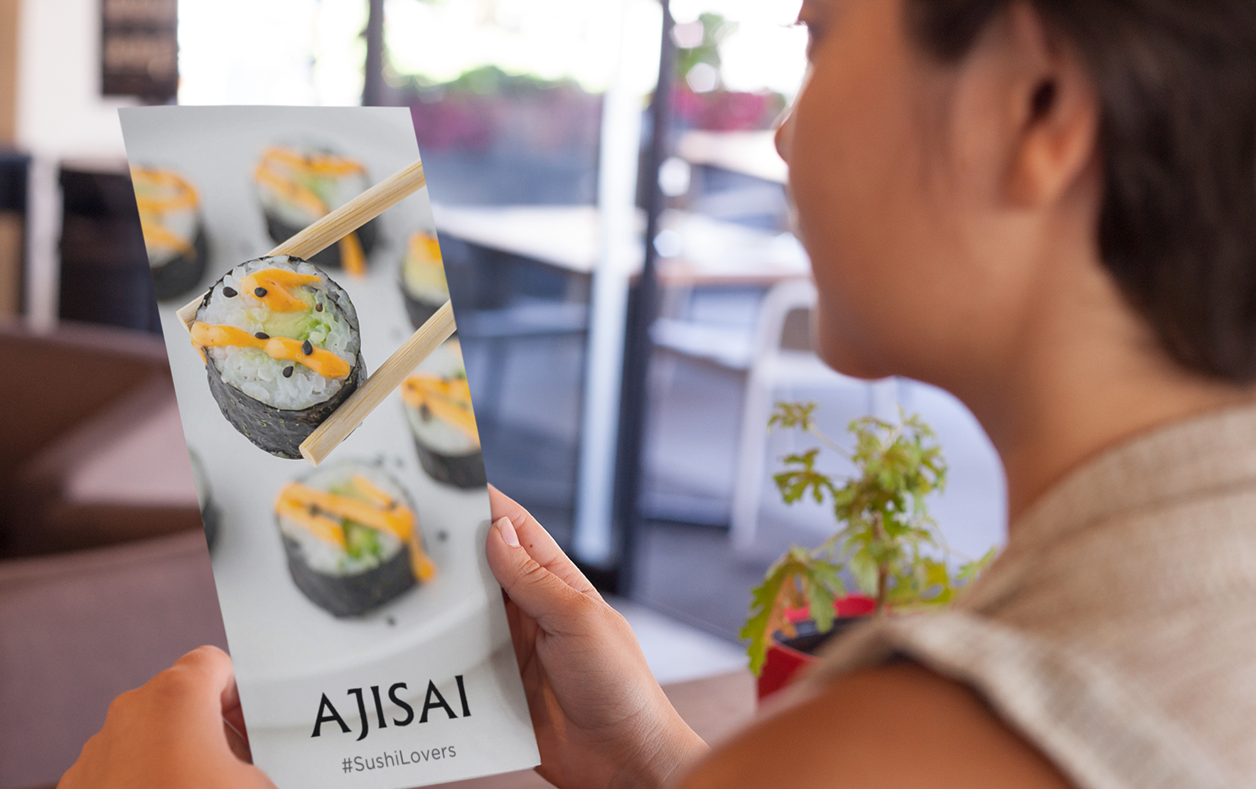young-girl-holding-a-menu-FINAL_while-at-a-restaurant-mockup-a14640